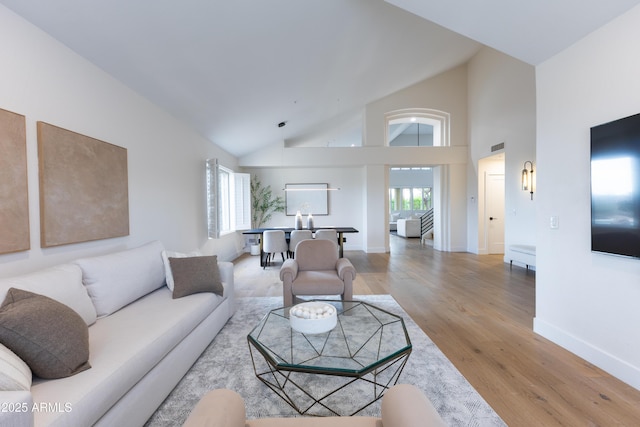 10875 E Mirasol Cir, Scottsdale, AZ 85255 - living room with baseboards, light wood finished floors, and high vaulted ceiling