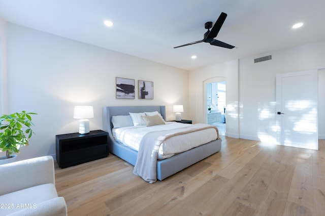 10875 E Mirasol Cir, Scottsdale, AZ 85255 - bedroom featuring ceiling fan, light wood finished floors, arched walkways, recessed lighting, and visible vents