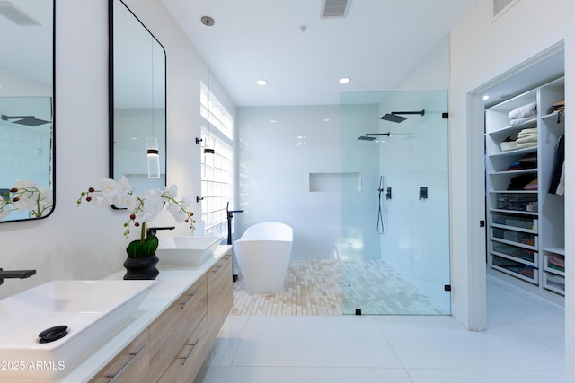 10875 E Mirasol Cir, Scottsdale, AZ 85255 - bathroom featuring visible vents, double vanity, a freestanding tub, a sink, and a stall shower