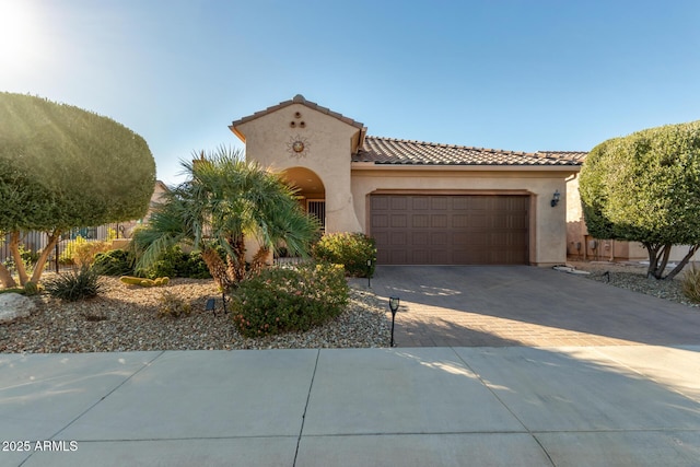 mediterranean / spanish-style house with a garage