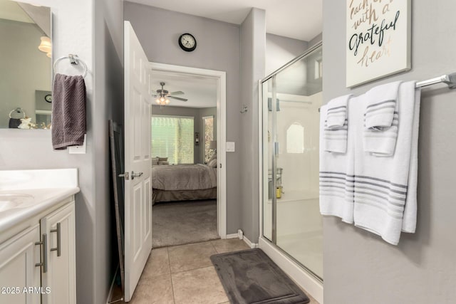 bathroom featuring ceiling fan, tile patterned floors, vanity, and a shower with door