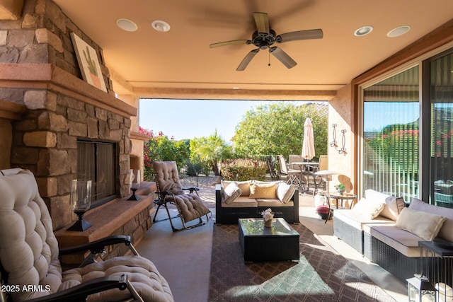 exterior space featuring an outdoor living space with a fireplace and ceiling fan