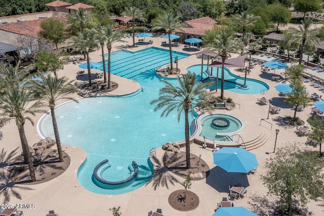 view of swimming pool featuring a community hot tub and a patio