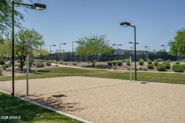 view of property's community featuring a yard and volleyball court