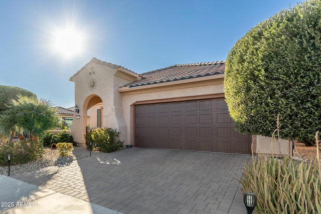 mediterranean / spanish-style house with a garage