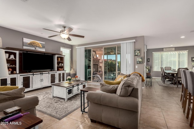 living room featuring light tile patterned floors and ceiling fan