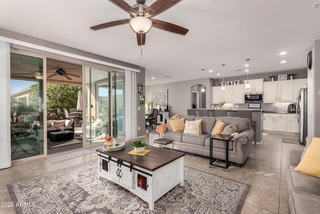 living room featuring light tile patterned floors and ceiling fan