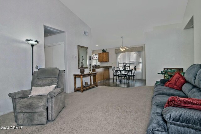 living room with carpet flooring, high vaulted ceiling, and ceiling fan