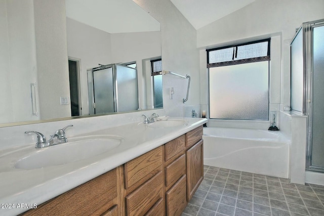 bathroom featuring vanity, separate shower and tub, and lofted ceiling