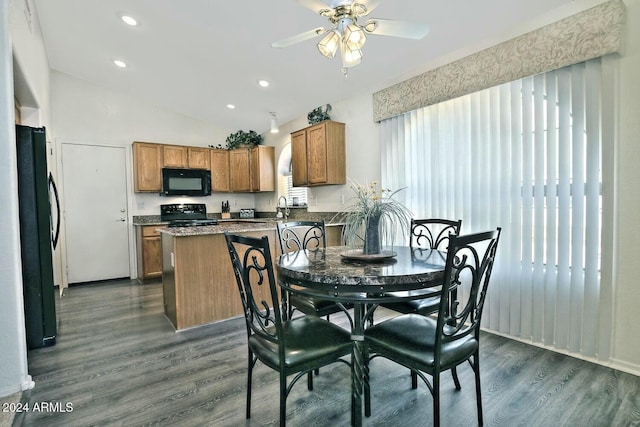 dining area featuring lofted ceiling, ceiling fan, sink, and dark hardwood / wood-style floors