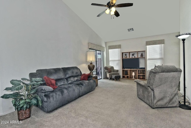 carpeted living room with ceiling fan and high vaulted ceiling