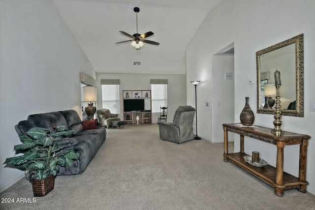 carpeted living room with ceiling fan and high vaulted ceiling