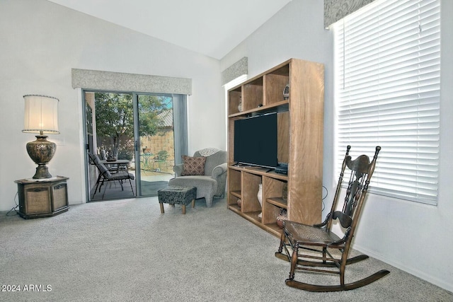 sitting room with carpet flooring and vaulted ceiling