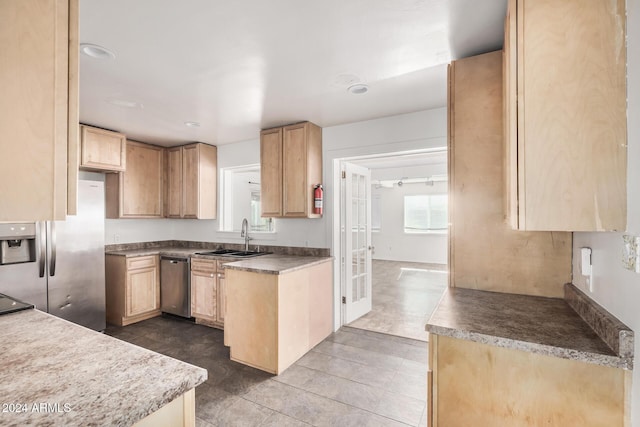 kitchen featuring light brown cabinets, sink, and appliances with stainless steel finishes