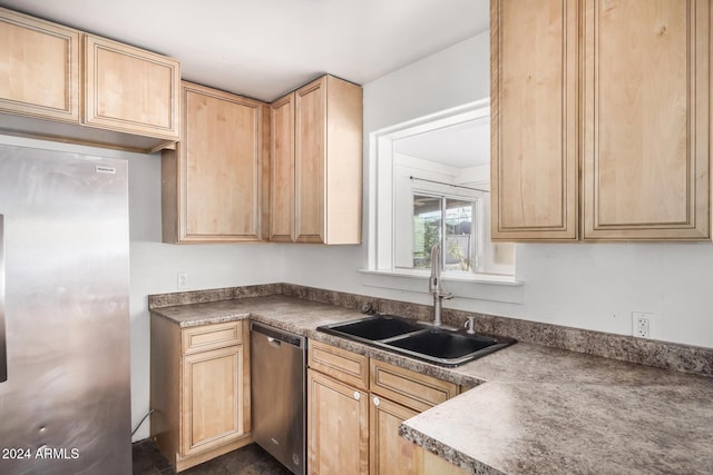 kitchen with light brown cabinets, stainless steel appliances, and sink