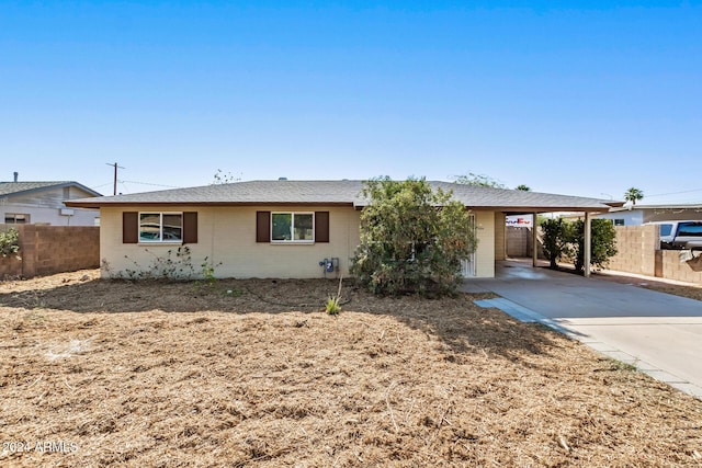 ranch-style home featuring a carport