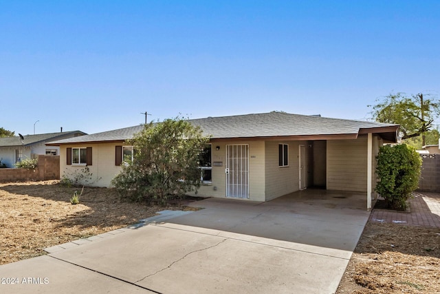 view of front of property featuring a carport