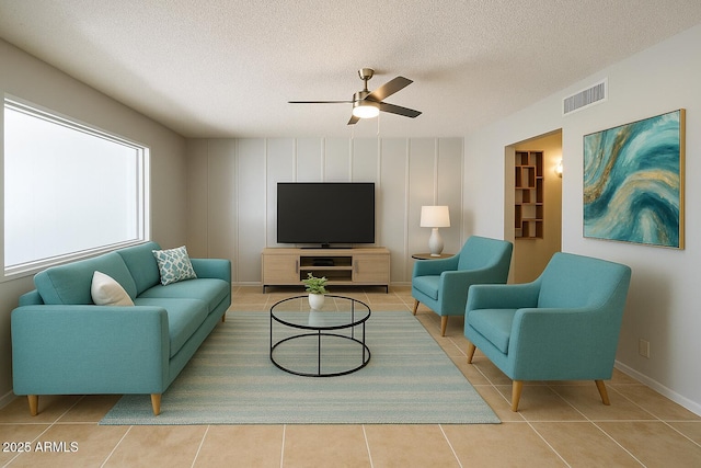 5342 E Des Moines St, Mesa, AZ 85205 - tiled living room featuring ceiling fan, a textured ceiling, and baseboards