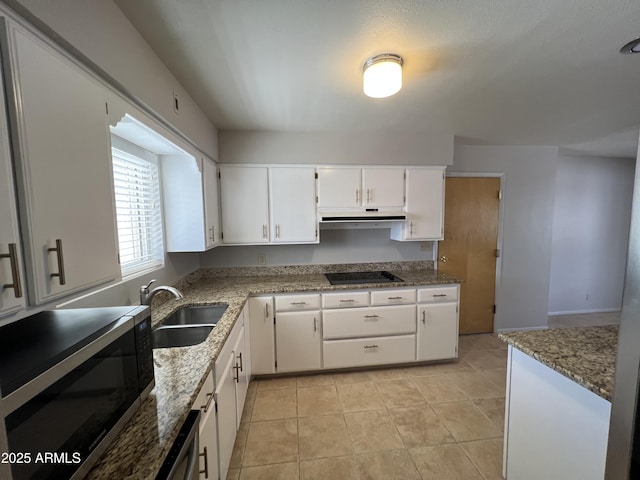 5342 E Des Moines St, Mesa, AZ 85205 - kitchen featuring stainless steel microwave, a sink, black electric stovetop, white cabinets, and light stone countertops