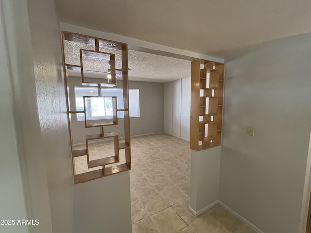 5342 E Des Moines St, Mesa, AZ 85205 - empty room with tile patterned flooring, a textured ceiling, and baseboards