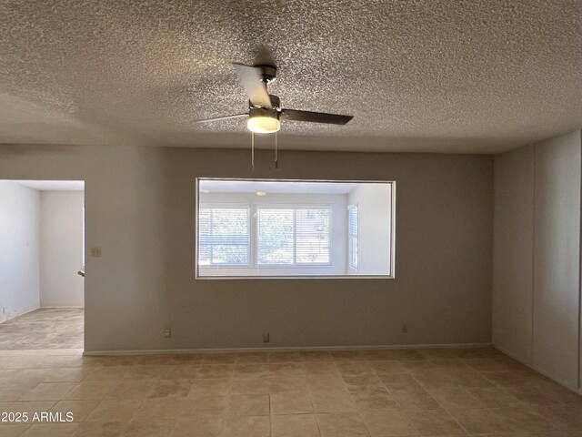 5342 E Des Moines St, Mesa, AZ 85205 - spare room with ceiling fan, light tile patterned floors, a textured ceiling, and baseboards