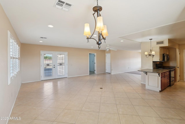 interior space with ceiling fan with notable chandelier and french doors