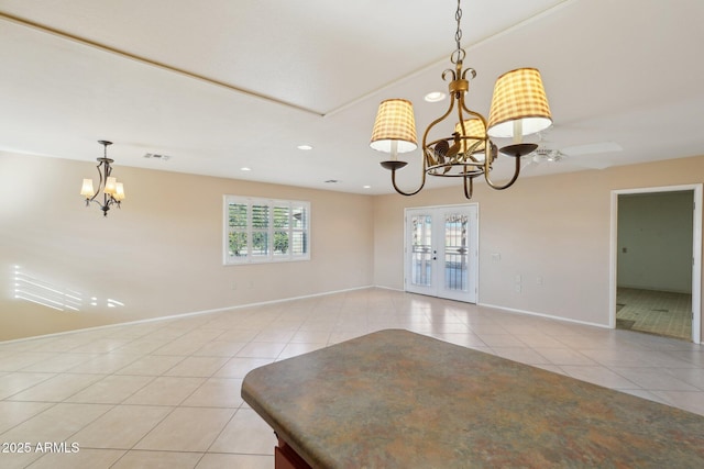 unfurnished dining area featuring light tile patterned floors, french doors, and ceiling fan