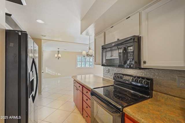 kitchen featuring pendant lighting, black appliances, decorative backsplash, light tile patterned floors, and a chandelier