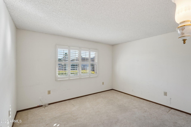 carpeted empty room with a textured ceiling