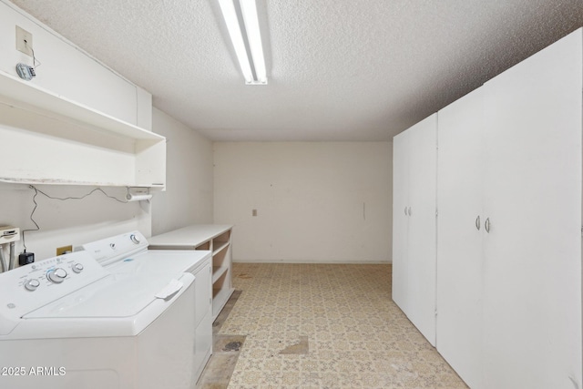 laundry room with independent washer and dryer and a textured ceiling