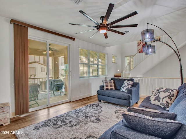 living room featuring hardwood / wood-style floors and ceiling fan