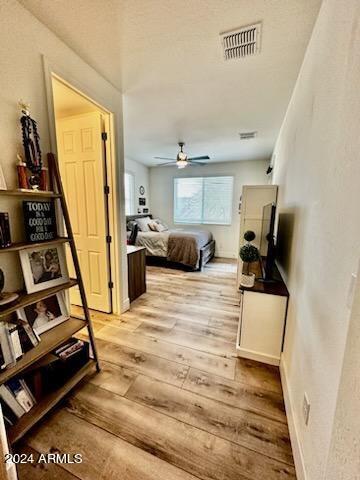 bedroom with ceiling fan and light hardwood / wood-style floors