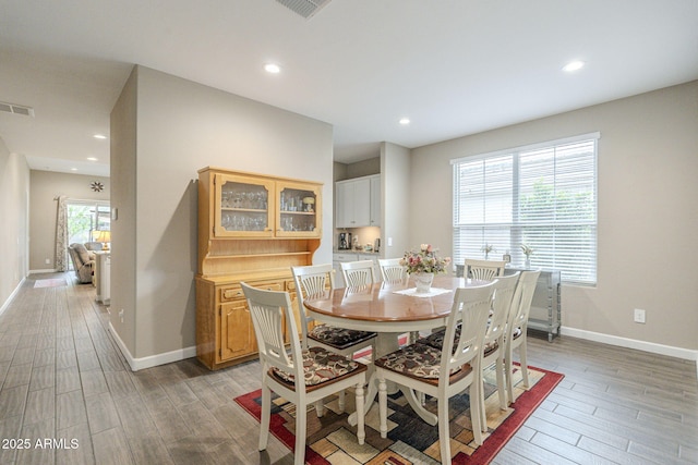 dining room with light wood-type flooring, visible vents, baseboards, and recessed lighting