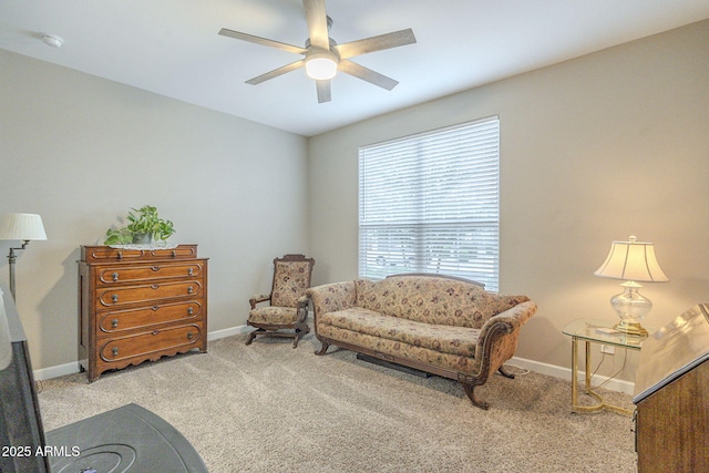 sitting room featuring carpet flooring, a ceiling fan, and baseboards