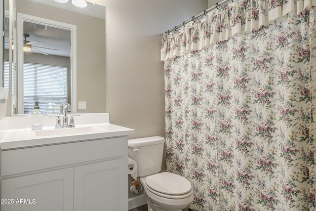 full bathroom featuring curtained shower, ceiling fan, toilet, a textured wall, and vanity