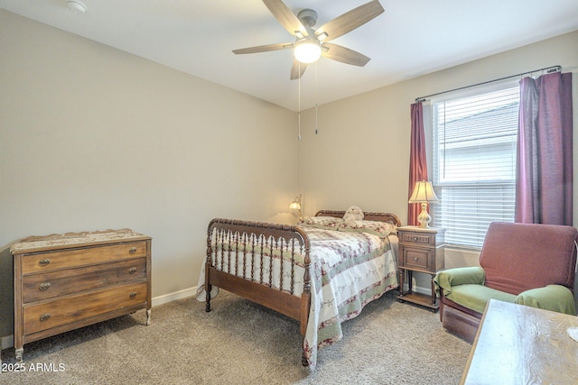 carpeted bedroom featuring baseboards and ceiling fan