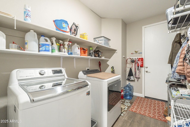 laundry room featuring laundry area, wood finished floors, and independent washer and dryer