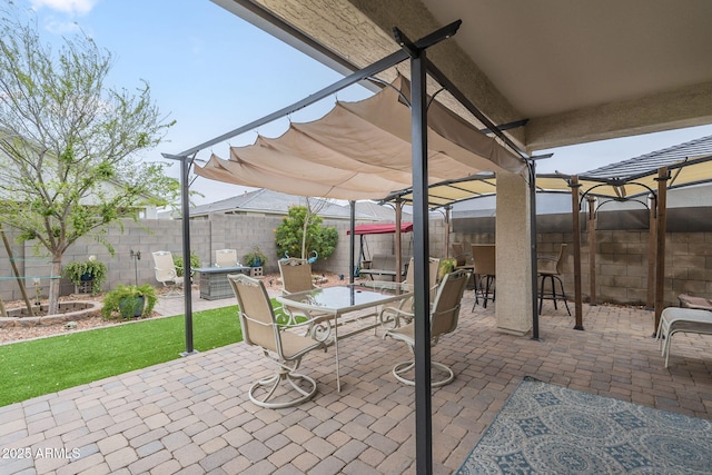 view of patio / terrace with outdoor dining area, a fenced backyard, and a pergola