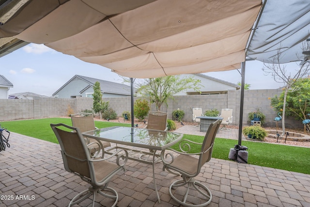 view of patio with outdoor dining area and a fenced backyard