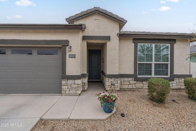 view of front of home with stone siding, stucco siding, concrete driveway, and a garage