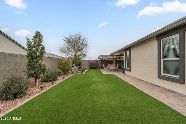 view of yard featuring a patio, a fenced backyard, and a pergola