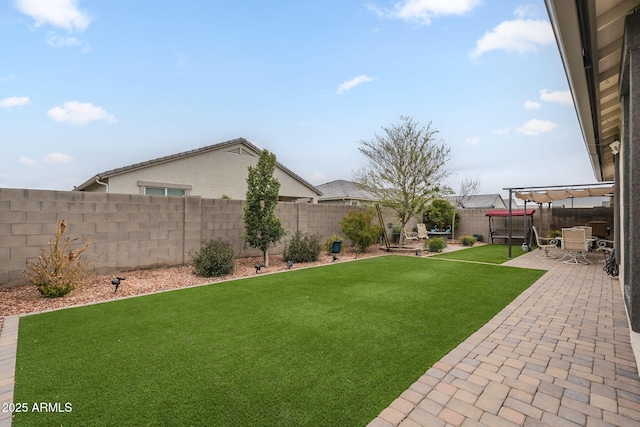 view of yard with a fenced backyard and a patio area