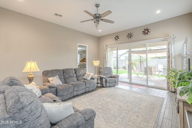 living area with recessed lighting, visible vents, and ceiling fan