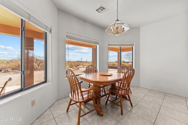 tiled dining area featuring a notable chandelier