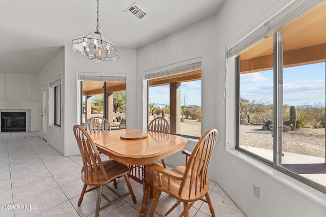 dining area with light tile patterned flooring, a chandelier, and a healthy amount of sunlight