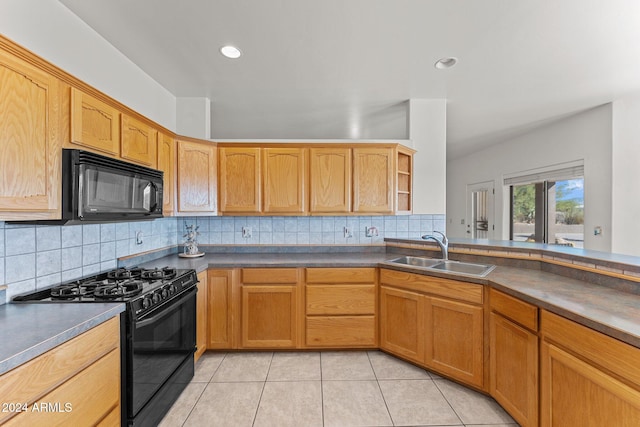 kitchen with black appliances, tasteful backsplash, sink, and light tile patterned floors