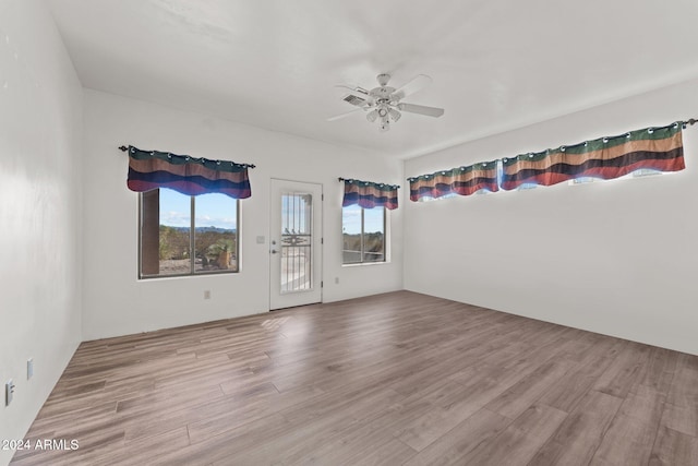 spare room with ceiling fan and light hardwood / wood-style floors