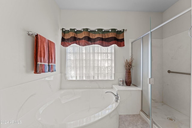 bathroom featuring plus walk in shower and tile patterned floors