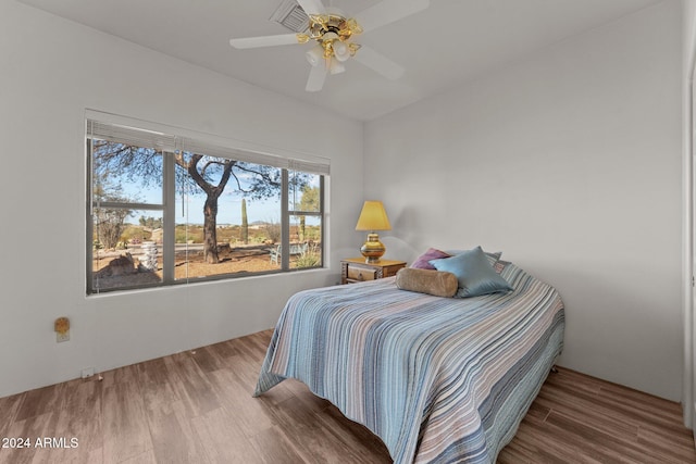 bedroom with hardwood / wood-style floors and ceiling fan