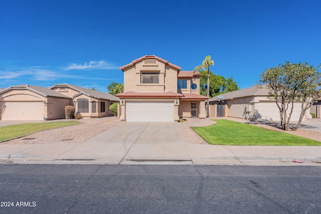 view of front of property featuring a front yard and a garage